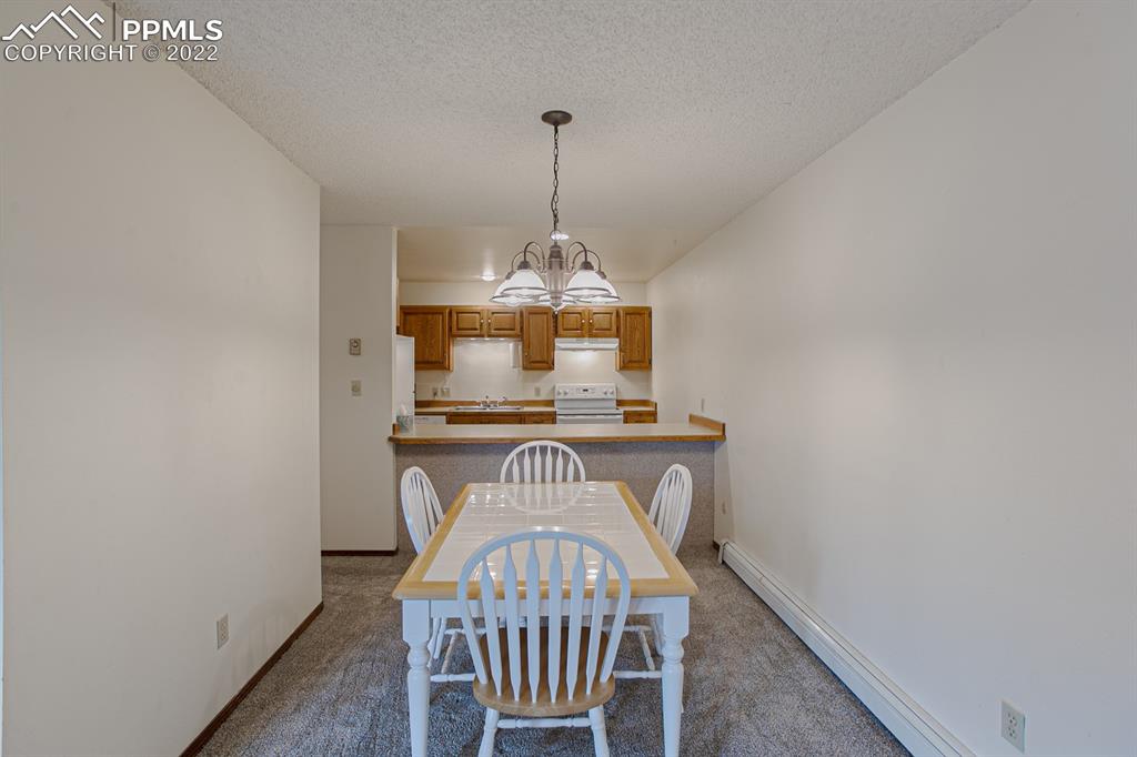 1140 Magic Lamp Way, Unit 3 Monument, CO 80132 - Photo 11 of 26 a view of dining room and wooden floor