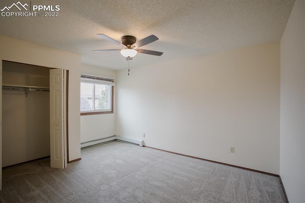 1140 Magic Lamp Way, Unit 3 Monument, CO 80132 - Photo 17 of 26 an empty room with windows and fan