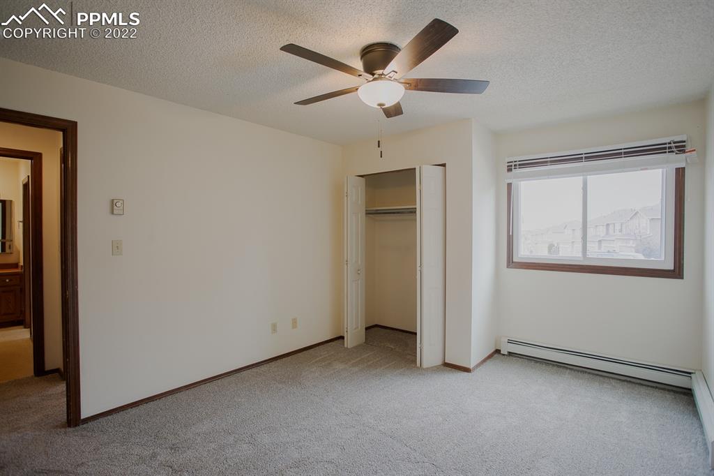 1140 Magic Lamp Way, Unit 3 Monument, CO 80132 - Photo 18 of 26 an empty room with ceiling fan and windows