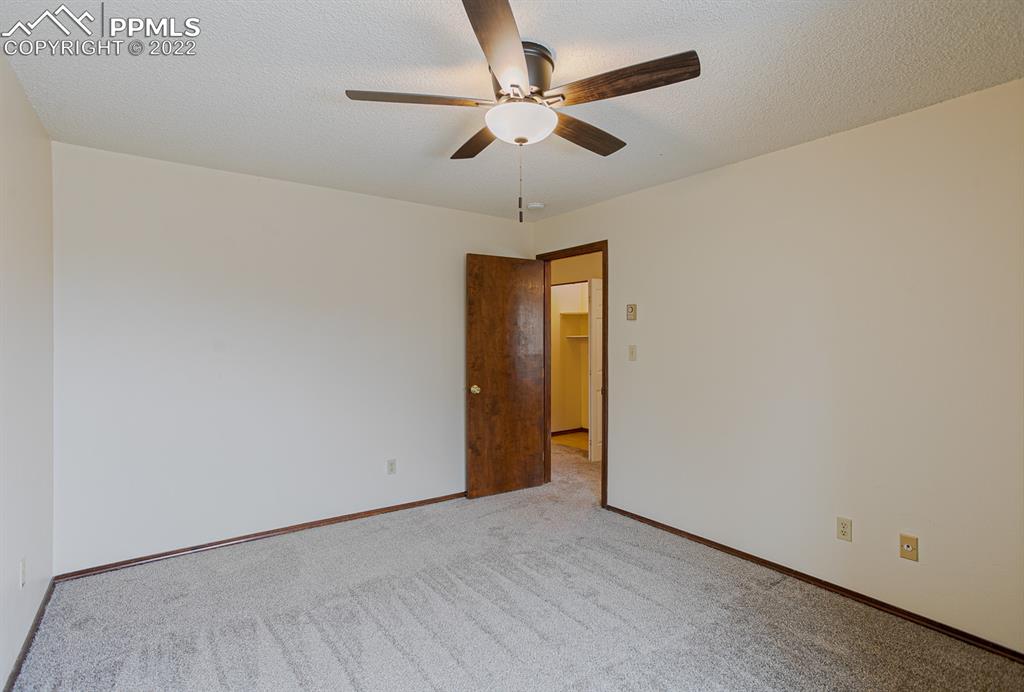 1140 Magic Lamp Way, Unit 3 Monument, CO 80132 - Photo 19 of 26 an empty room with closet and a chandelier fan