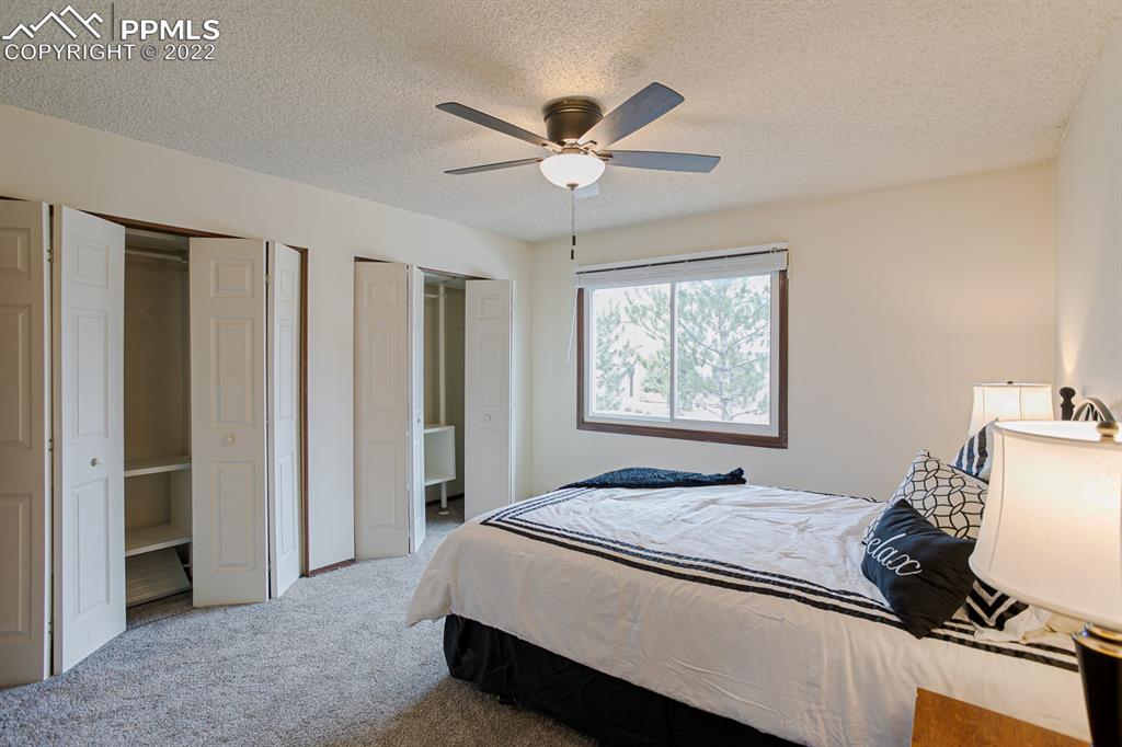 1140 Magic Lamp Way, Unit 3 Monument, CO 80132 - Photo 20 of 26 a bedroom with a bed and a window