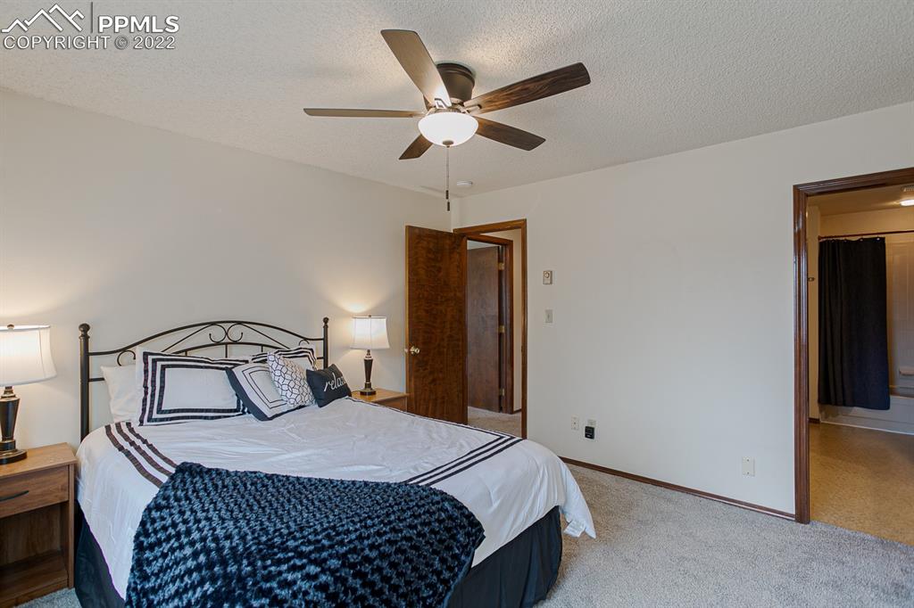 1140 Magic Lamp Way, Unit 3 Monument, CO 80132 - Photo 22 of 26 a bedroom with a bed and a closet