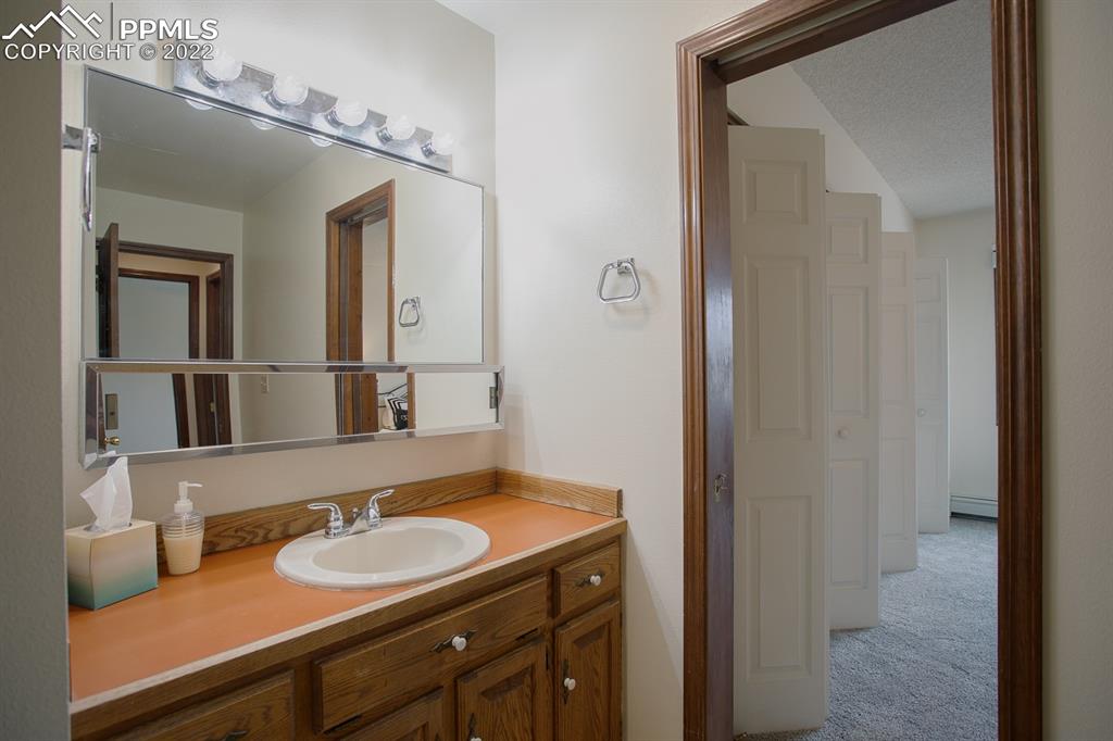 1140 Magic Lamp Way, Unit 3 Monument, CO 80132 - Photo 25 of 26 a bathroom with a sink and a mirror