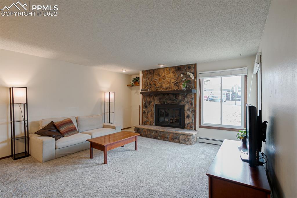 1140 Magic Lamp Way, Unit 3 Monument, CO 80132 - Photo 6 of 26 a living room with furniture and a fireplace