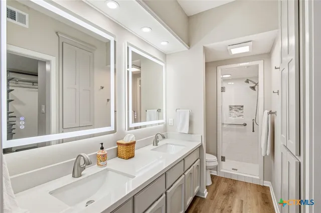 a bathroom with a sink a mirror and a shower
