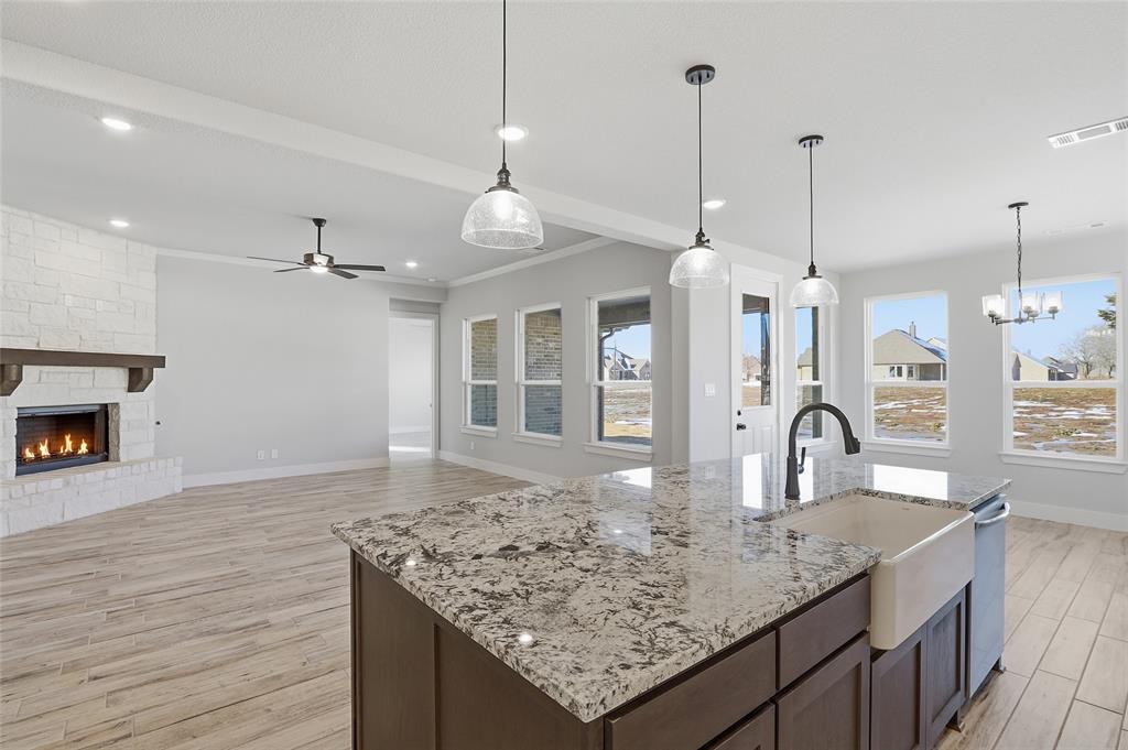 290 Cofer Road Leonard, TX 75452 - Photo 39 of 40 a kitchen with kitchen island granite countertop a sink and chandelier