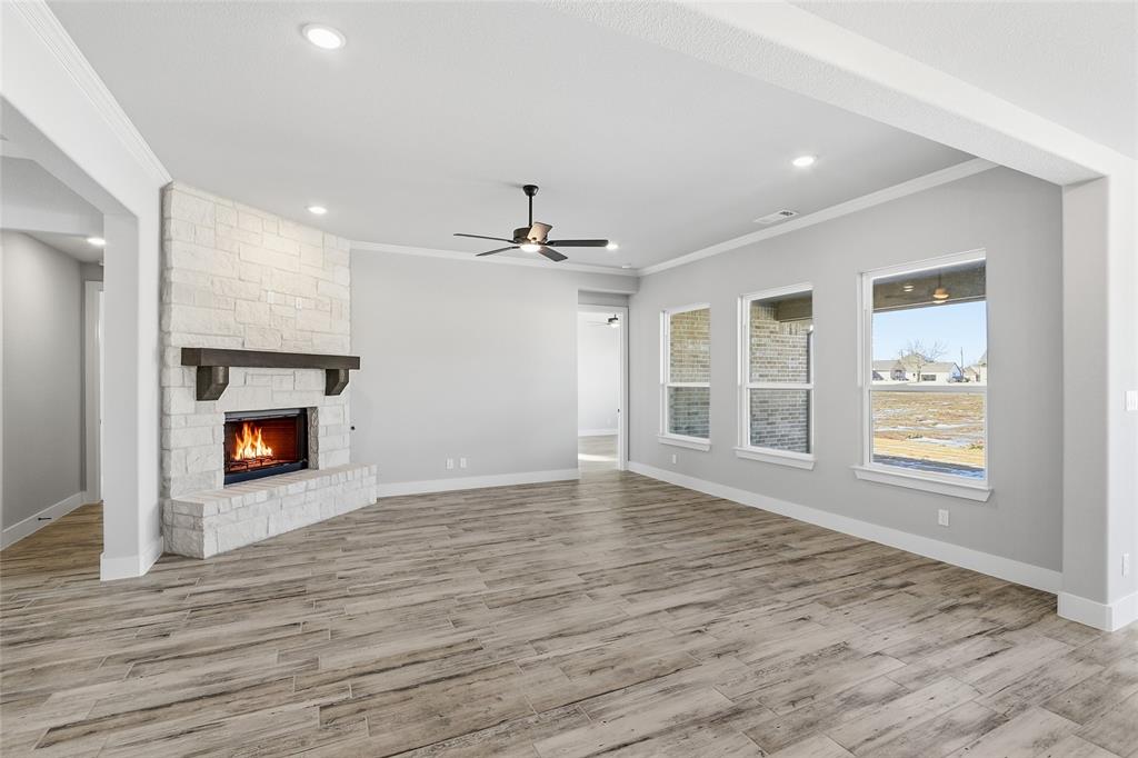 290 Cofer Road Leonard, TX 75452 - Photo 15 of 40 an empty room with wooden floor fireplace and windows