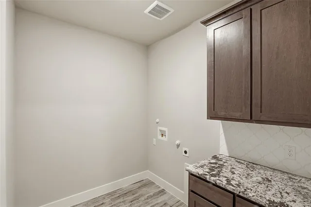 a kitchen with a stove and cabinets