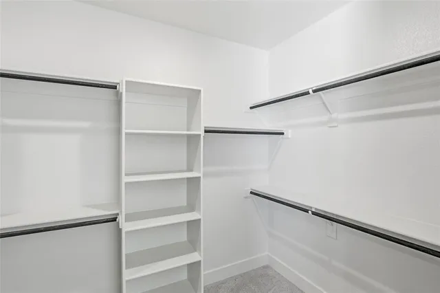 a view of an empty walk in closet with empty racks