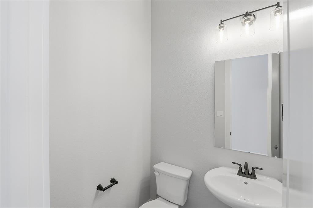 290 Cofer Road Leonard, TX 75452 - Photo 34 of 40 a bathroom with a sink mirror and toilet