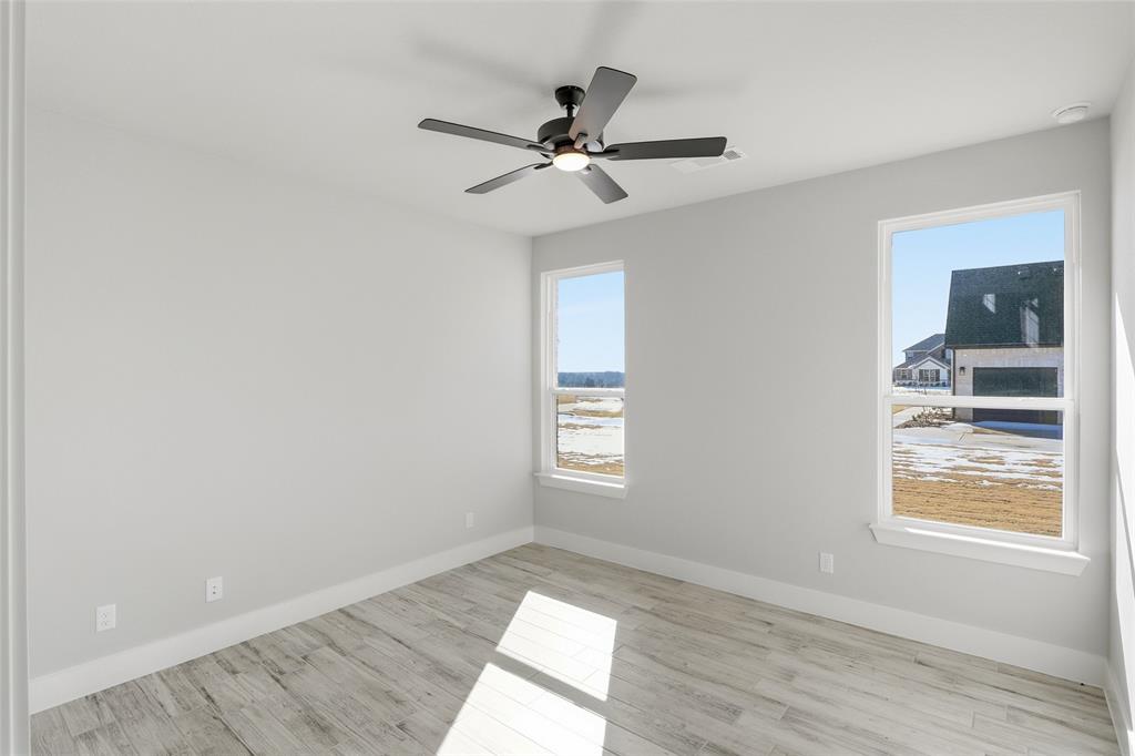 290 Cofer Road Leonard, TX 75452 - Photo 36 of 40 a view of empty room with wooden floor and fan