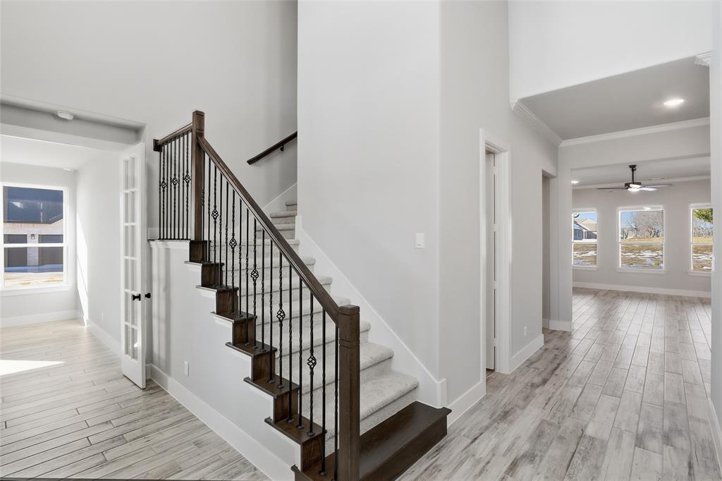 290 Cofer Road Leonard, TX 75452 - Photo 6 of 40 a view of a hallway with wooden floor and staircase