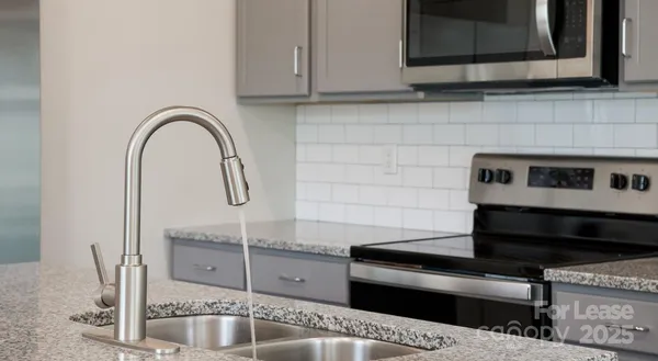 a kitchen with a sink and a microwave