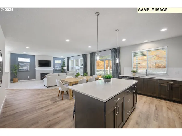 a kitchen with a table chairs and a wooden floor