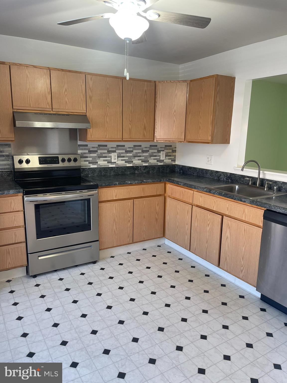332 Liborio Drive Middletown, DE 19709 - Photo 3 of 46 a kitchen with granite countertop a sink a stove and cabinets