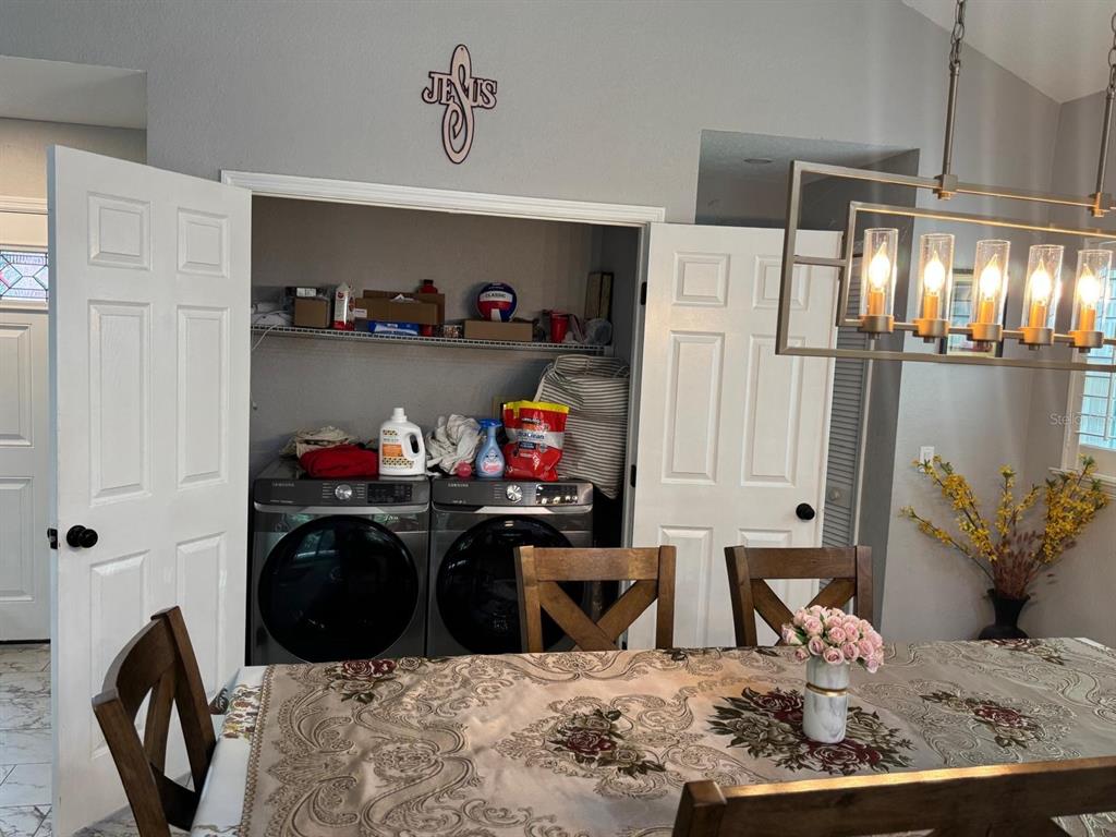 5221 Spike Horn Drive New Port Richey, FL 34653 - Photo 12 of 34 a kitchen with stainless steel appliances kitchen island granite countertop a refrigerator and a stove