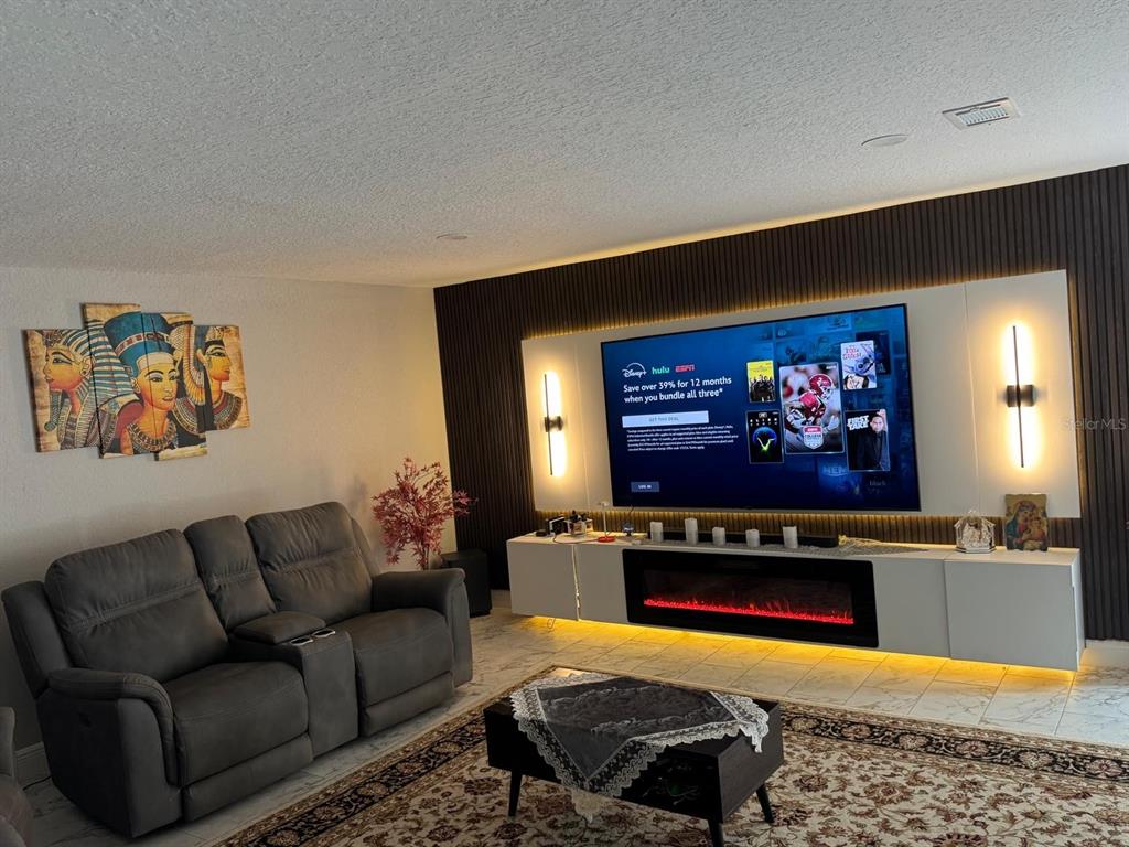 5221 Spike Horn Drive New Port Richey, FL 34653 - Photo 13 of 34 a living room with furniture and a flat screen tv