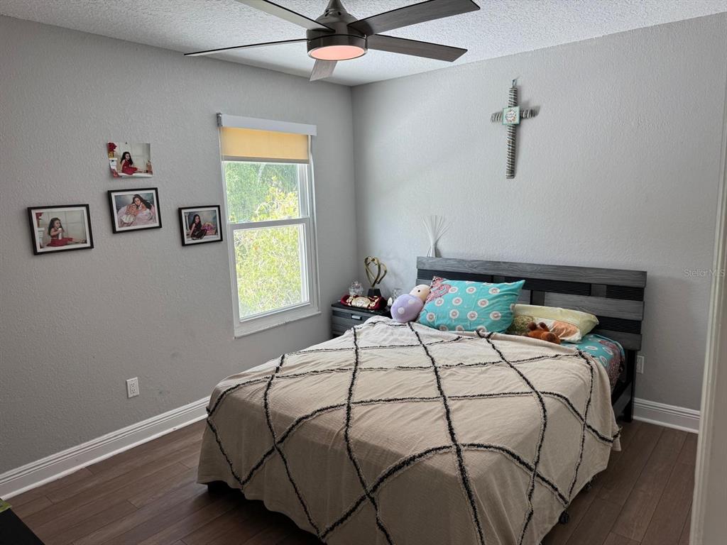 5221 Spike Horn Drive New Port Richey, FL 34653 - Photo 20 of 34 a bedroom with a bed and window