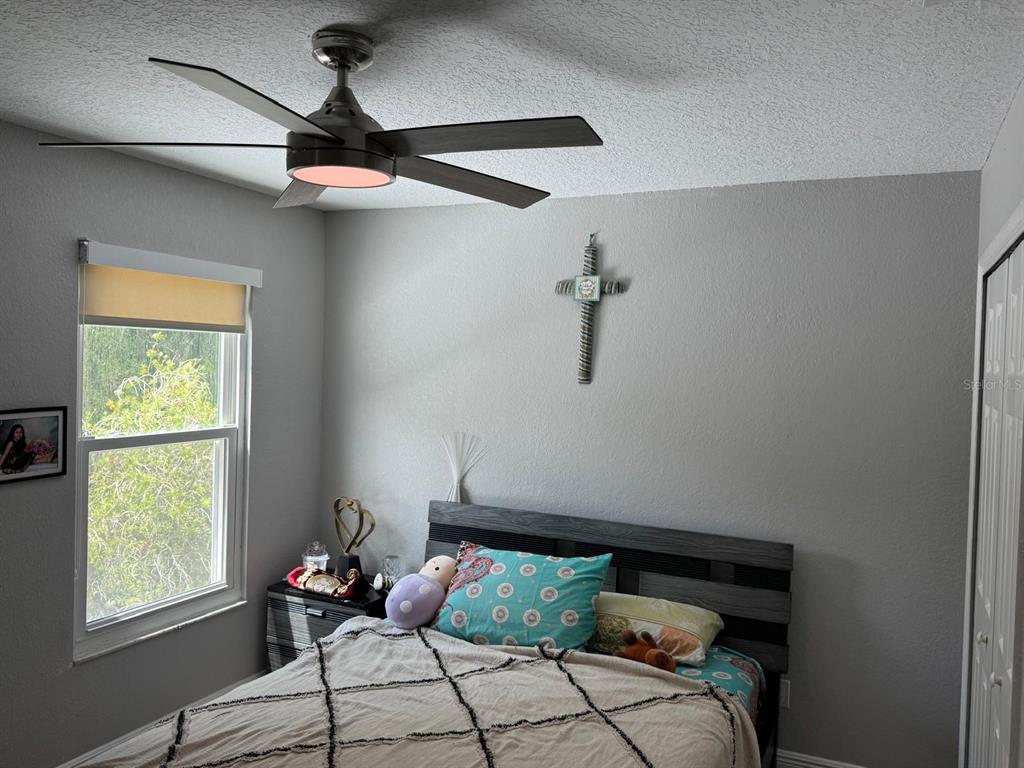 5221 Spike Horn Drive New Port Richey, FL 34653 - Photo 27 of 34 a bedroom with a bed and a window