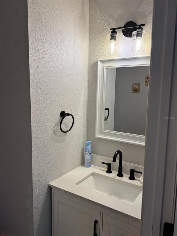 5221 Spike Horn Drive New Port Richey, FL 34653 - Photo 28 of 34 a bathroom with a sink vanity and mirror