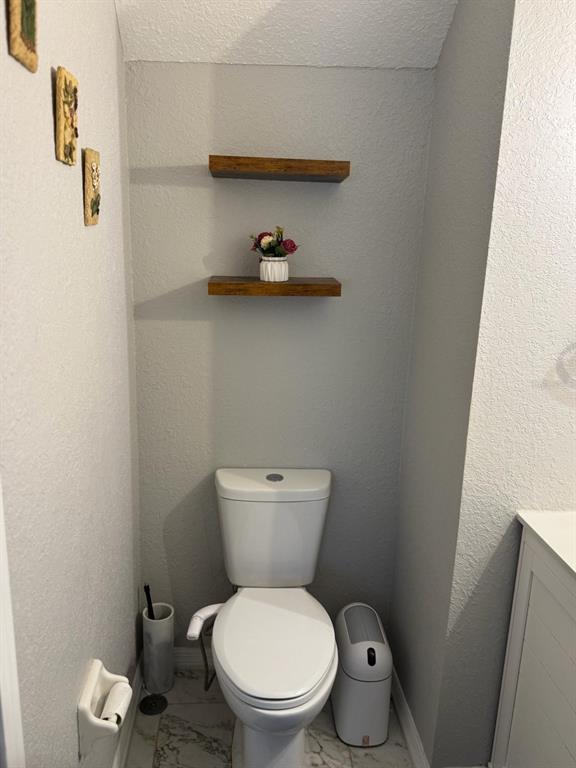 5221 Spike Horn Drive New Port Richey, FL 34653 - Photo 29 of 34 a white toilet sitting next to a wooden floor