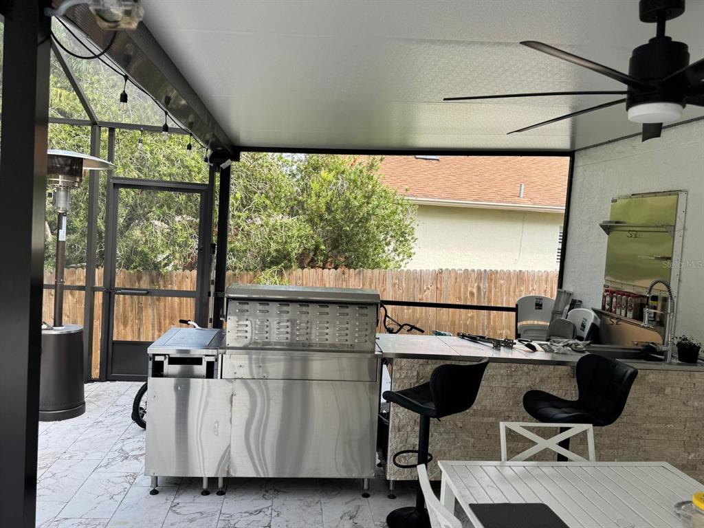 5221 Spike Horn Drive New Port Richey, FL 34653 - Photo 32 of 34 a living room with furniture a flat screen tv and a large window