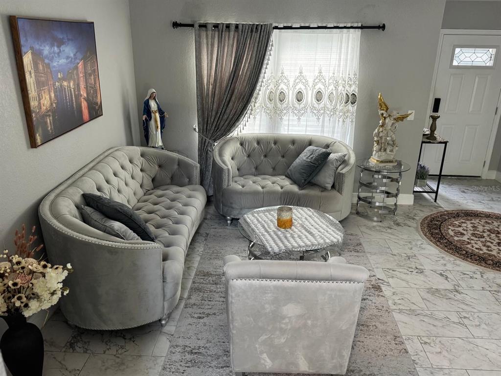 5221 Spike Horn Drive New Port Richey, FL 34653 - Photo 5 of 34 a living room with furniture and a large window