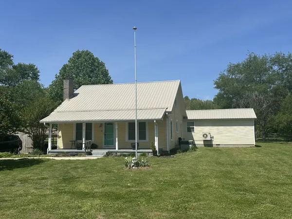 a front view of a house with a garden and porch