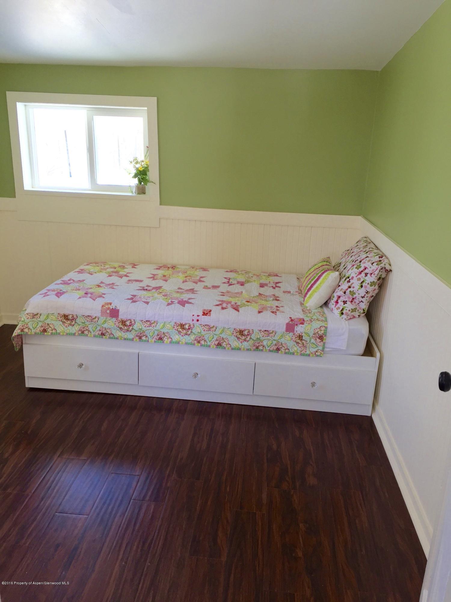 400 East 2nd Street Rifle, CO 81650 - Photo 3 of 22 a bed sitting in a bedroom next to a window