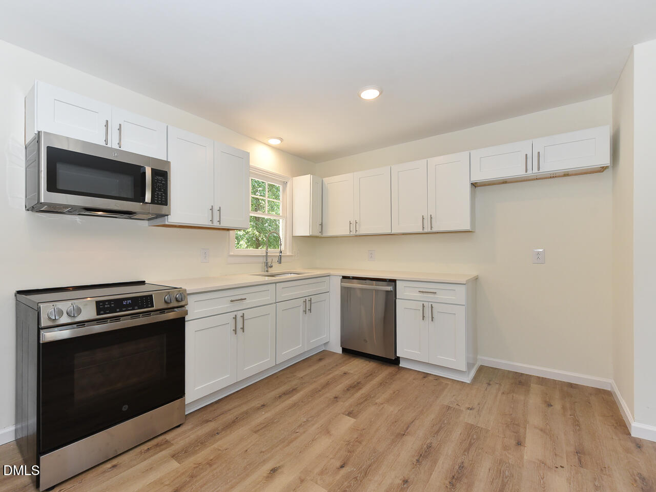 939 Cheves Road Zebulon, NC 27597 - Photo 4 of 21 a kitchen with a sink stove and microwave