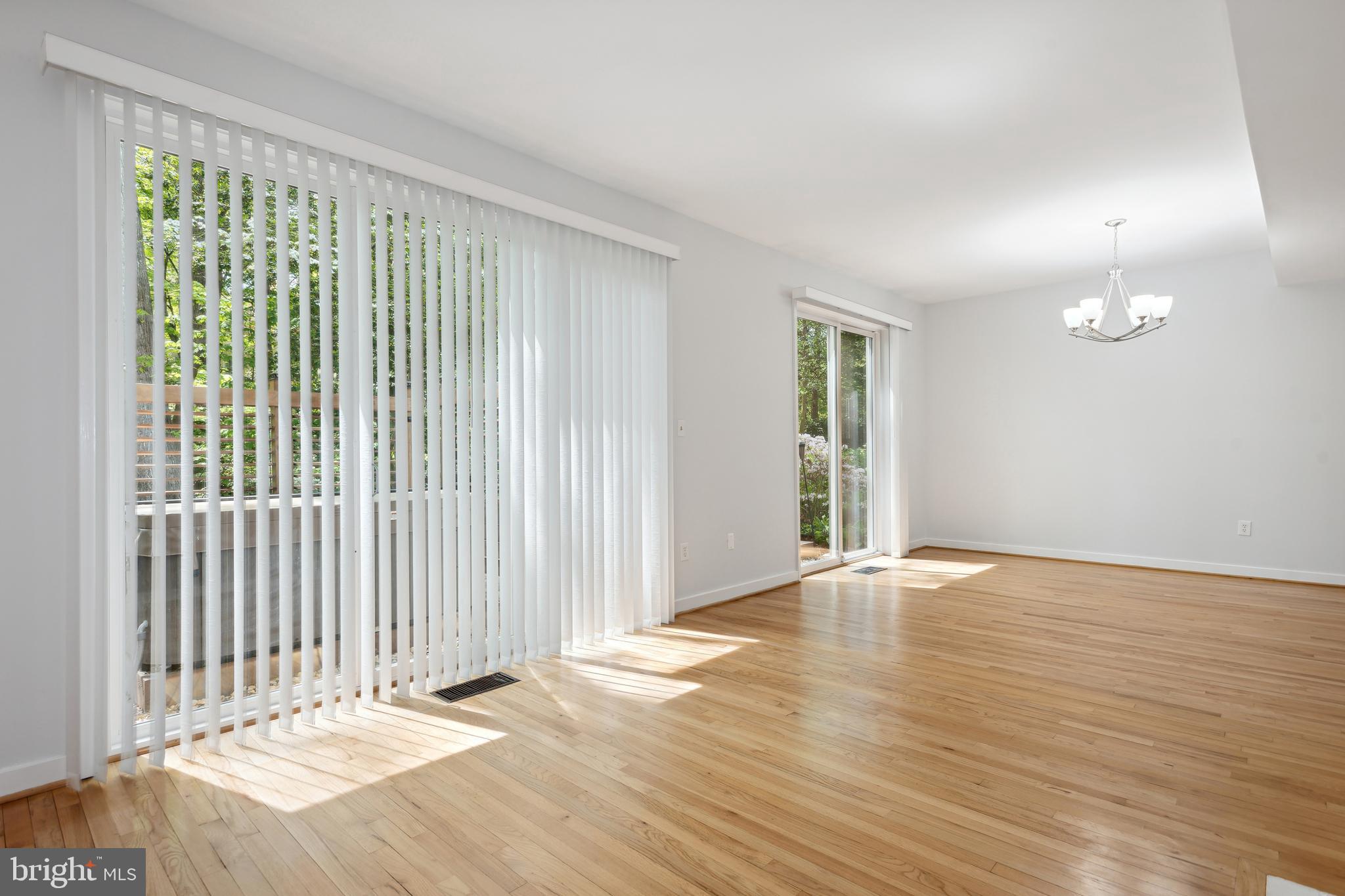 11439 Waterview Cluster Reston, VA 20190 - Photo 16 of 61 an empty room with wooden floor and windows