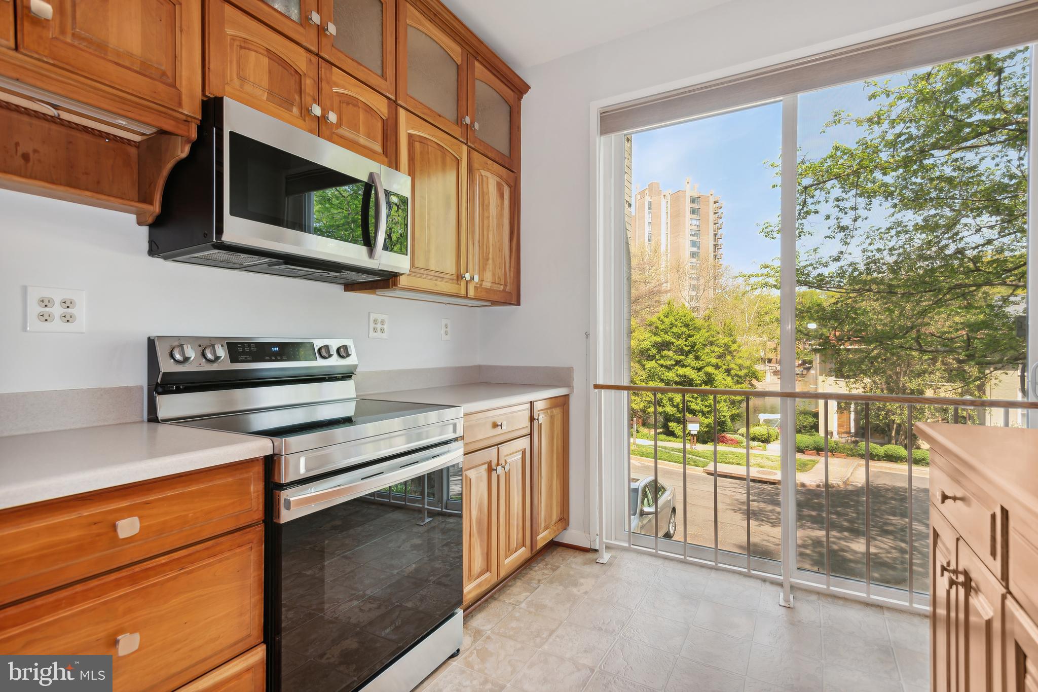 11439 Waterview Cluster Reston, VA 20190 - Photo 18 of 61 a kitchen with stainless steel appliances a stove microwave and cabinets