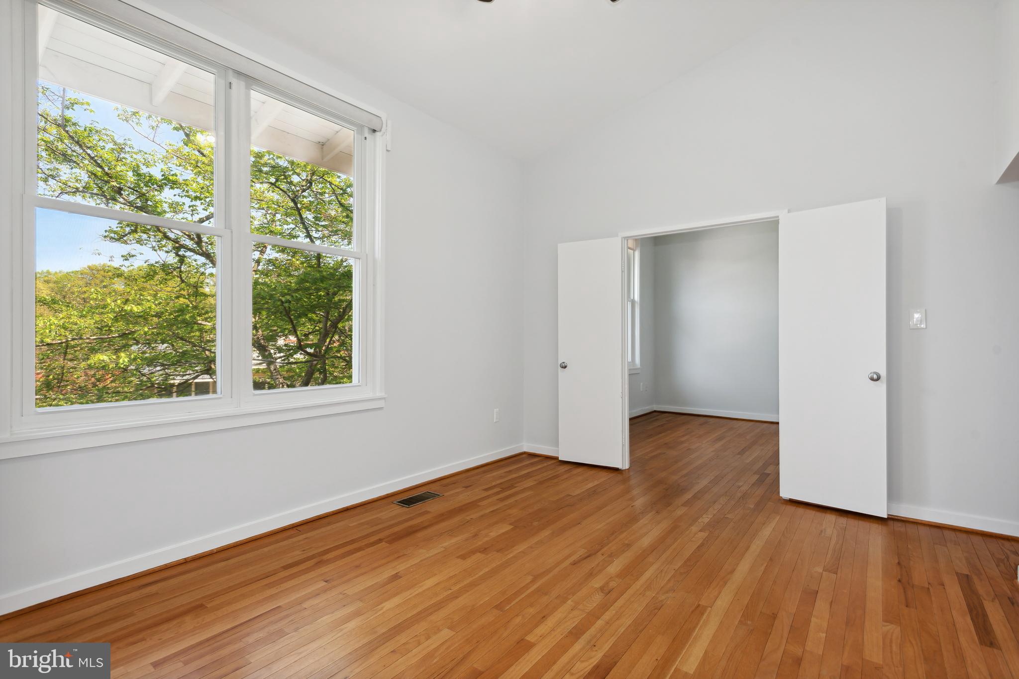 11439 Waterview Cluster Reston, VA 20190 - Photo 25 of 61 a view of an empty room with wooden floor and a window