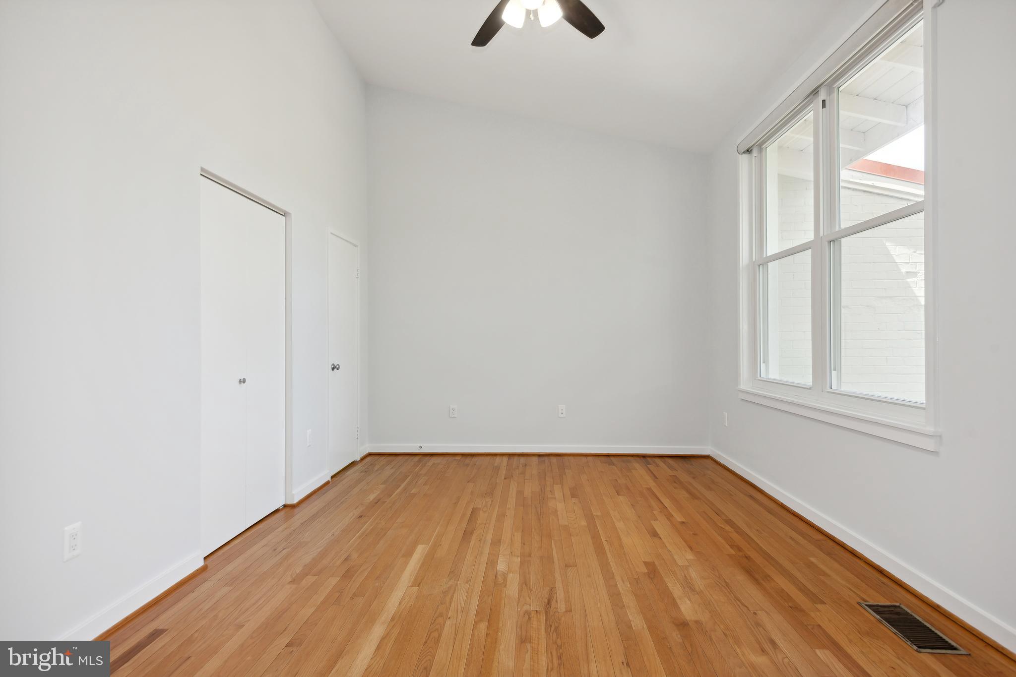 11439 Waterview Cluster Reston, VA 20190 - Photo 27 of 61 an empty room with a window and wooden floor