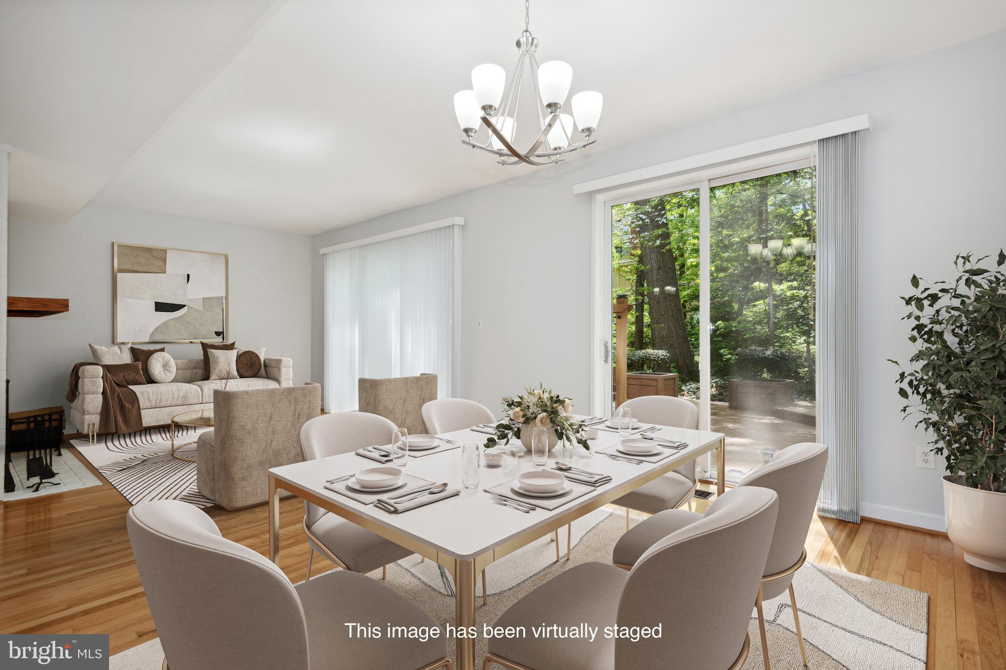 11439 Waterview Cluster Reston, VA 20190 - Photo 3 of 61 a view of a dining room with furniture wooden floor and a chandelier