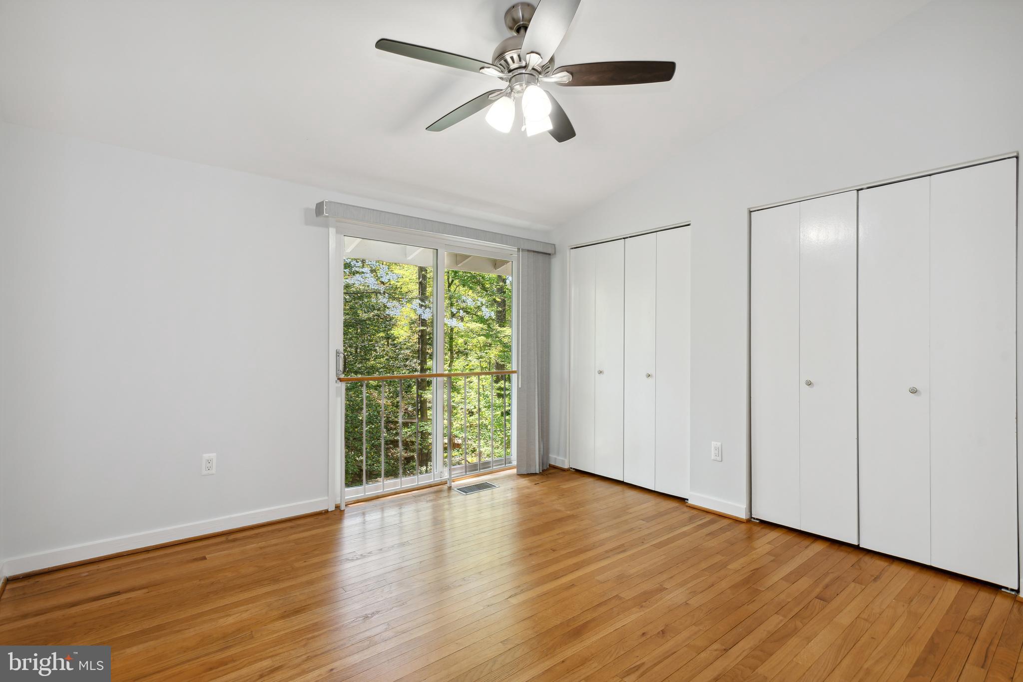 11439 Waterview Cluster Reston, VA 20190 - Photo 34 of 61 an empty room with wooden floor fan and windows