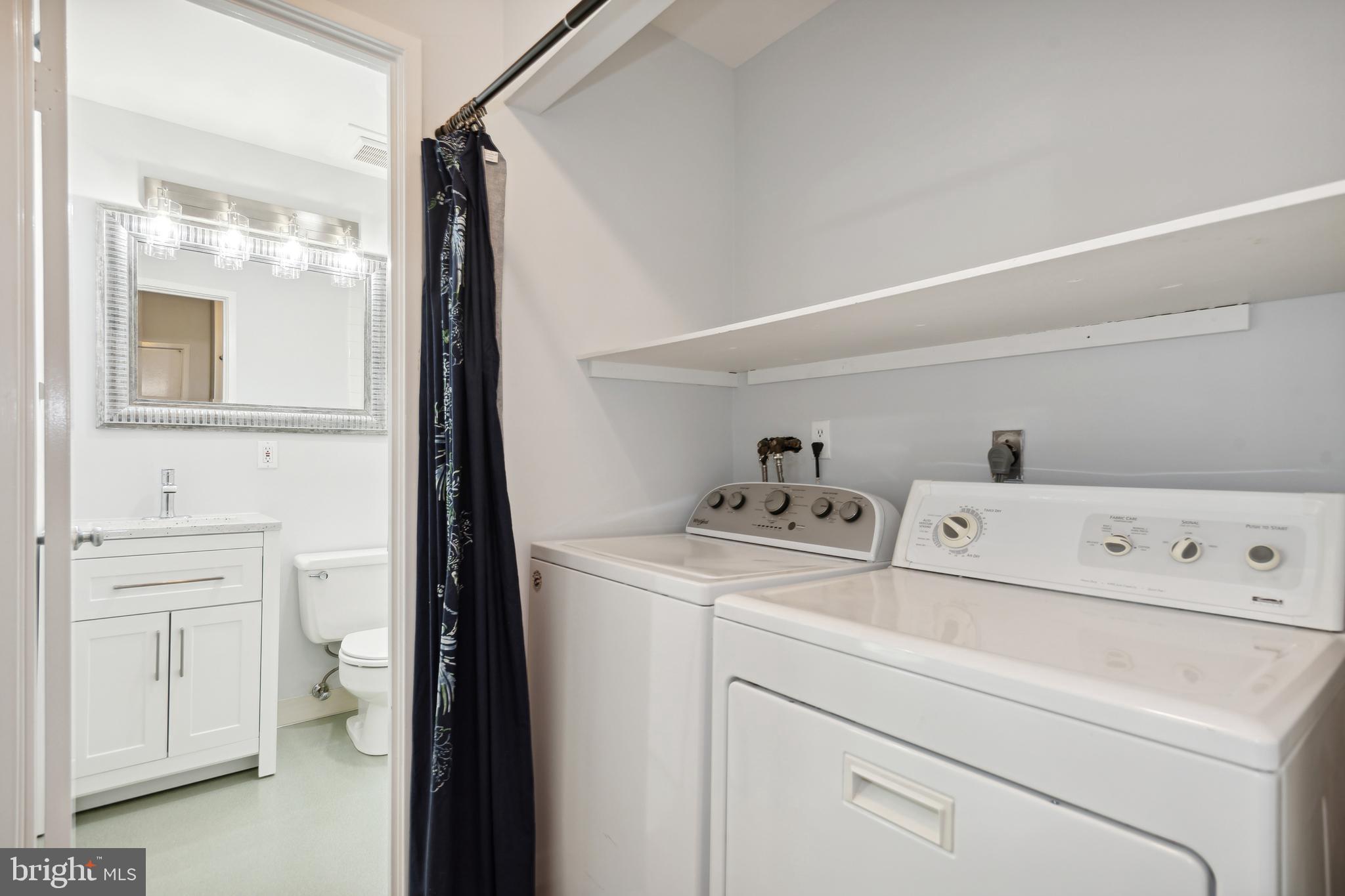 11439 Waterview Cluster Reston, VA 20190 - Photo 36 of 61 a view of washer and dryer with bathroom in the background