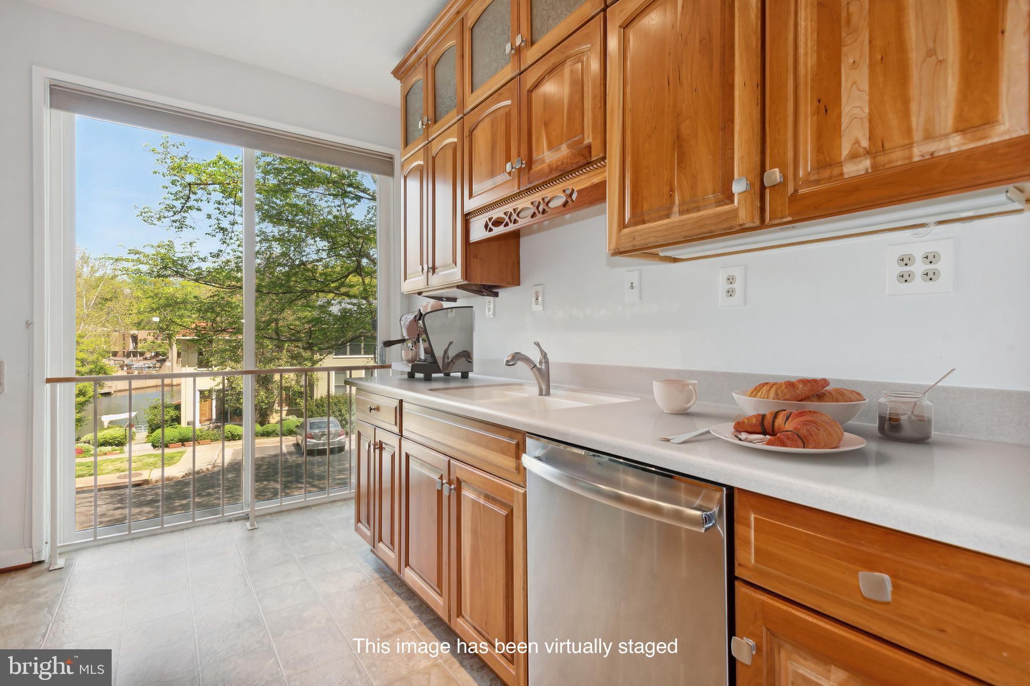 11439 Waterview Cluster Reston, VA 20190 - Photo 4 of 61 a kitchen with stainless steel appliances granite countertop a sink and cabinets
