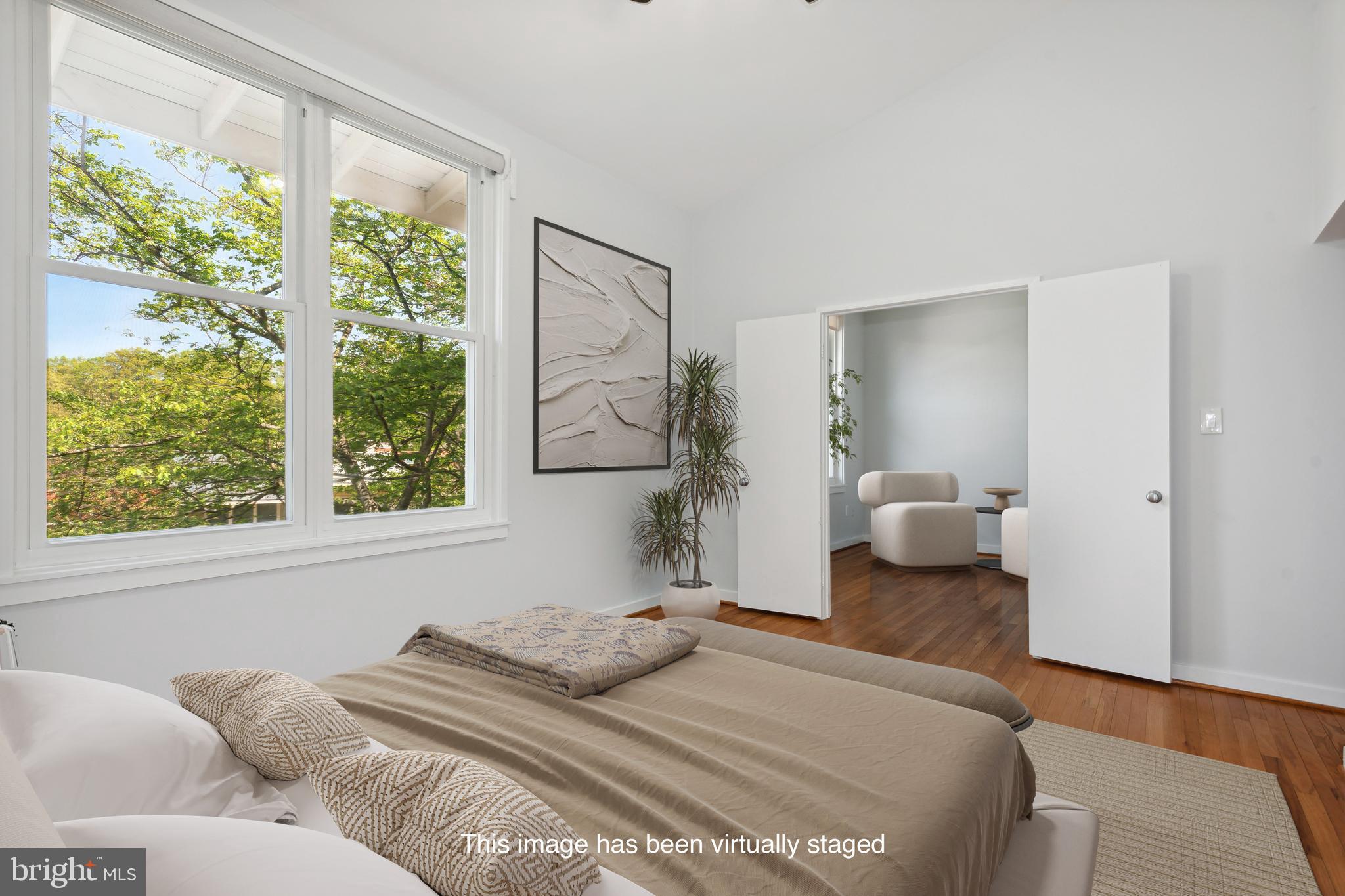 11439 Waterview Cluster Reston, VA 20190 - Photo 5 of 61 a bedroom with a bed and large windows