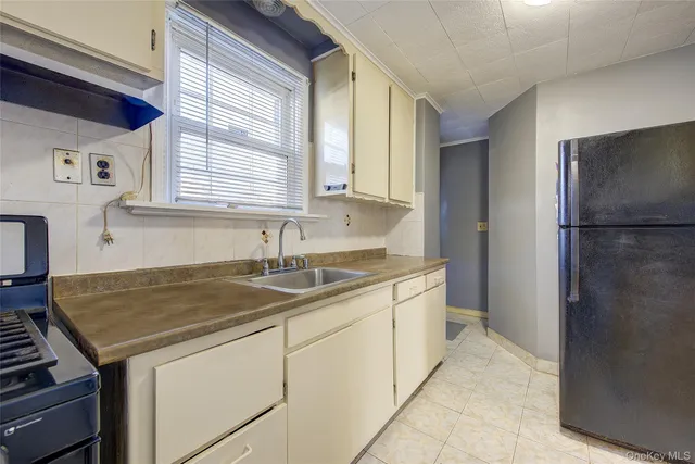 a kitchen with a sink stove and refrigerator