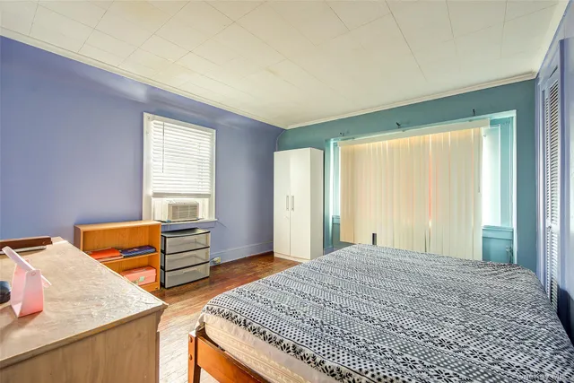 a bedroom with natural light and a bed