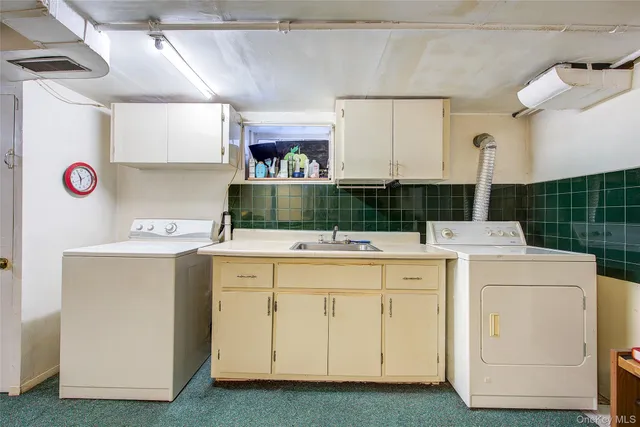 a view of a kitchen with a sink and dishwasher a stove top oven with wooden floor