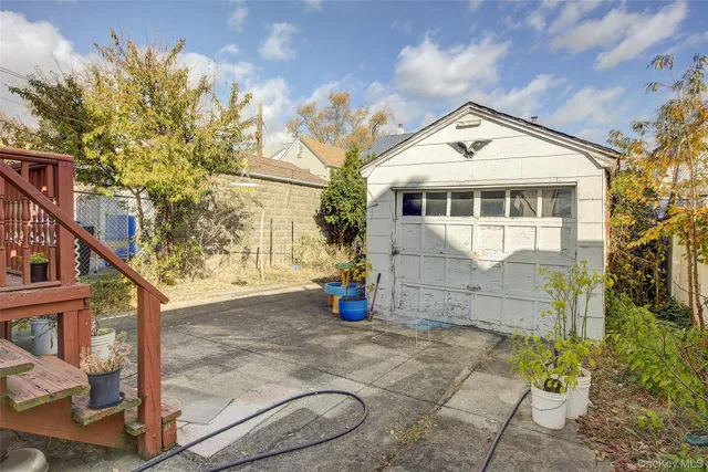 a front view of a house with a yard and plant