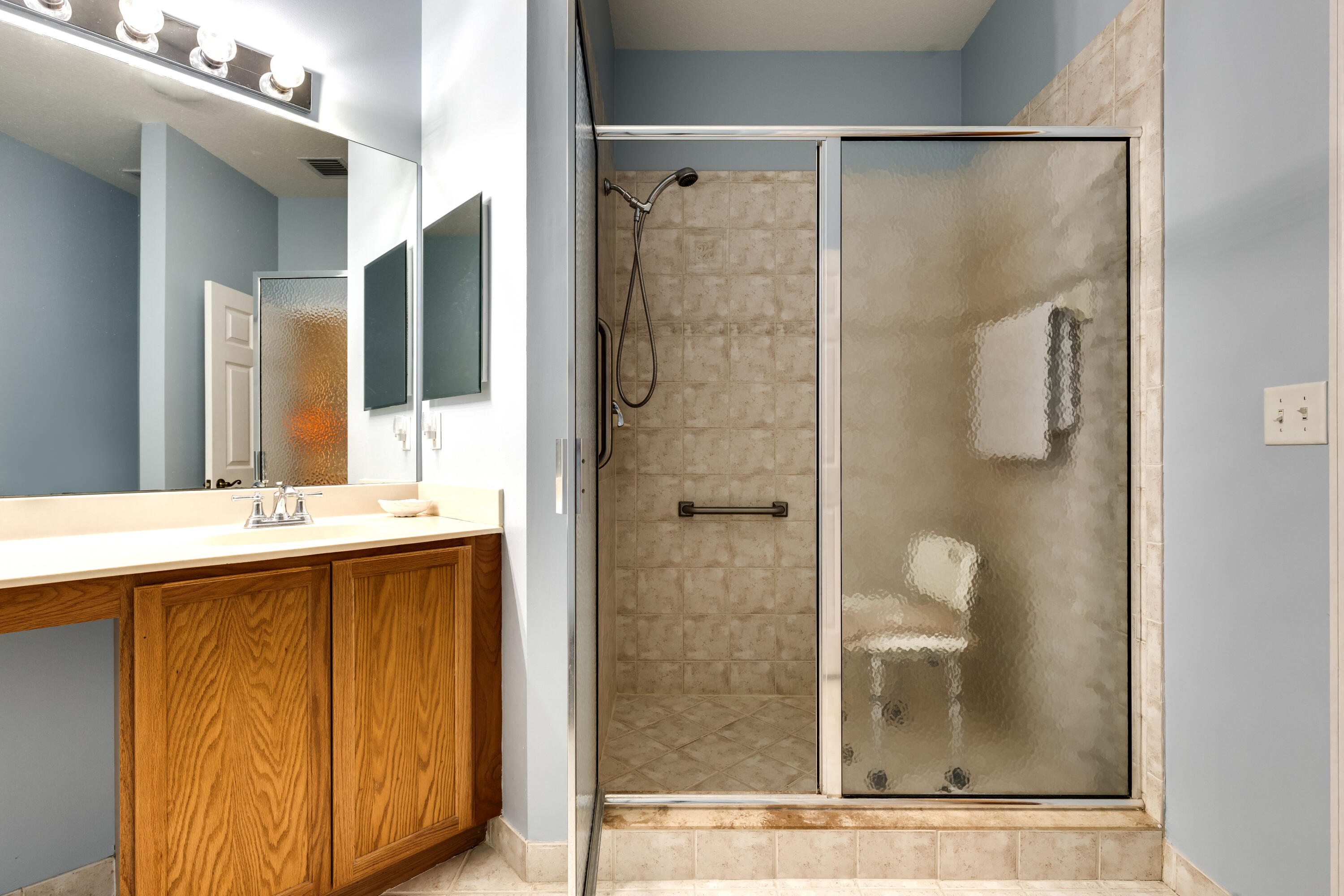 156 Village Boulevard, Unit E Tequesta, FL 33469 - Photo 22 of 36 a bathroom with a shower and a sink