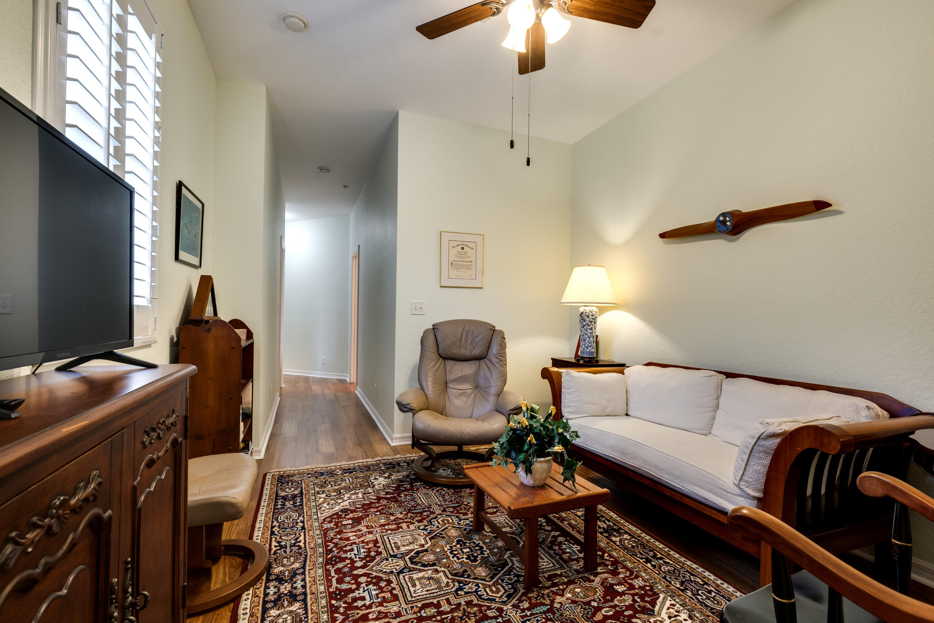 156 Village Boulevard, Unit E Tequesta, FL 33469 - Photo 28 of 36 a living room with furniture and a flat screen tv
