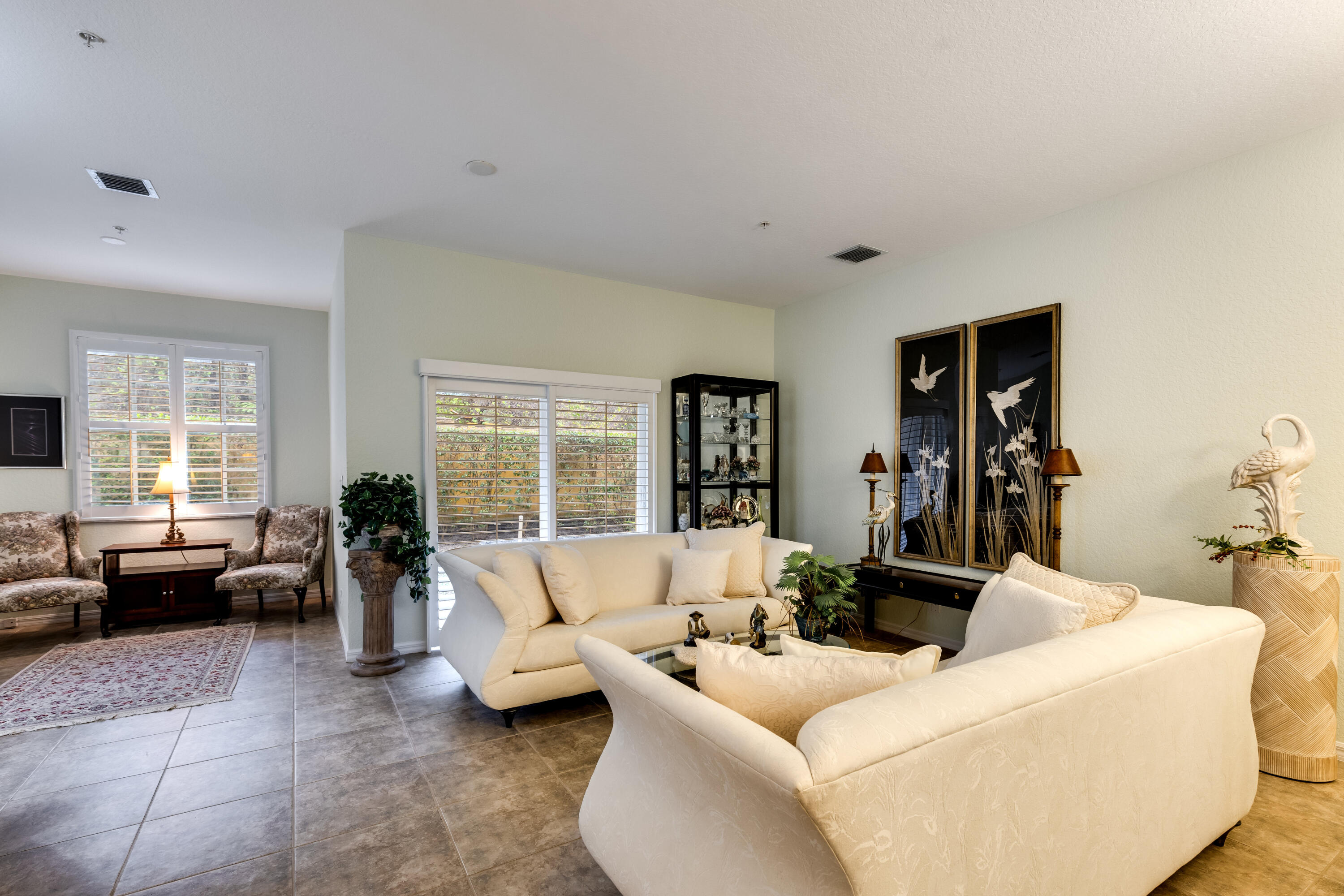 156 Village Boulevard, Unit E Tequesta, FL 33469 - Photo 4 of 36 a living room with furniture and a large window