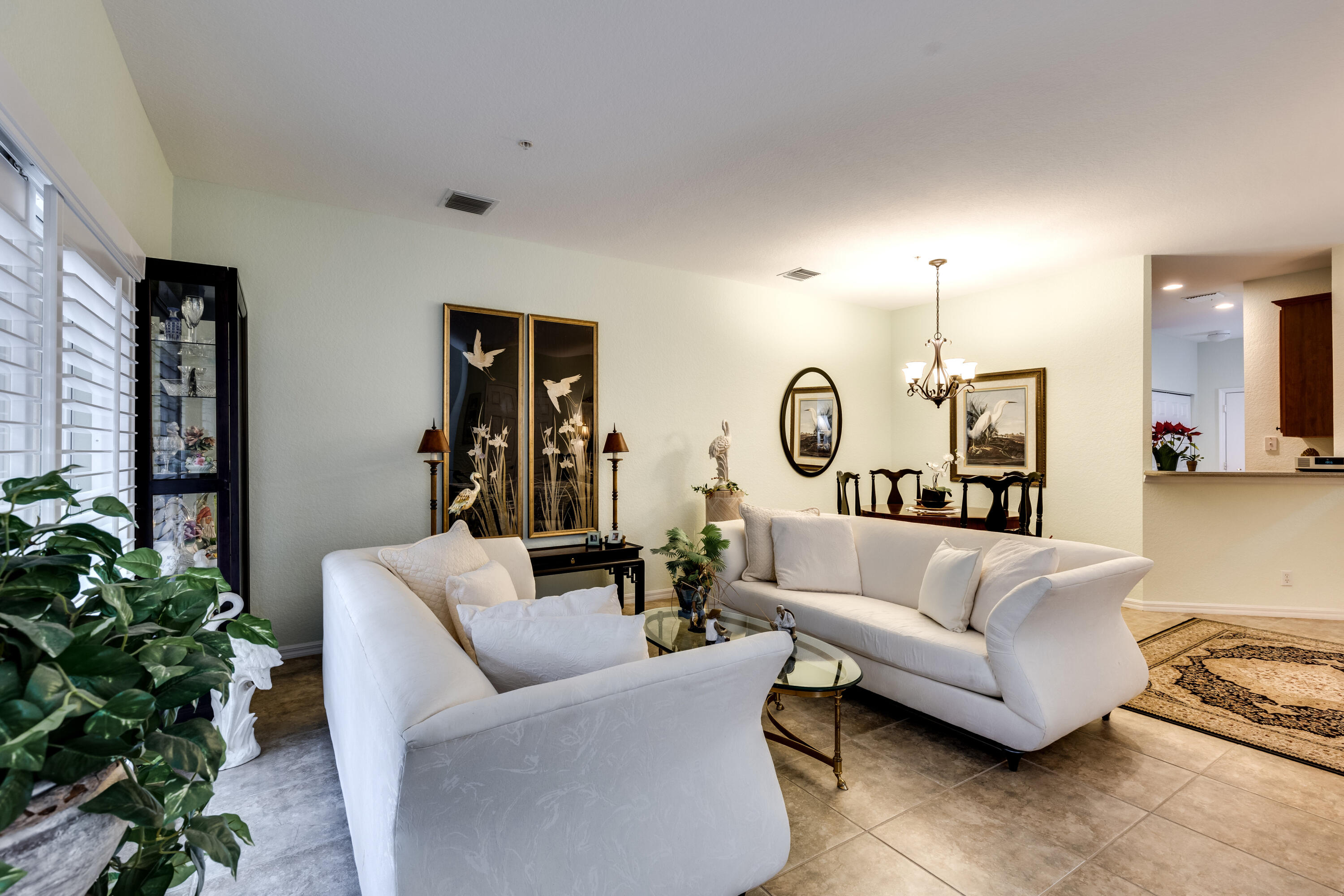 156 Village Boulevard, Unit E Tequesta, FL 33469 - Photo 6 of 36 a living room with furniture and a large window