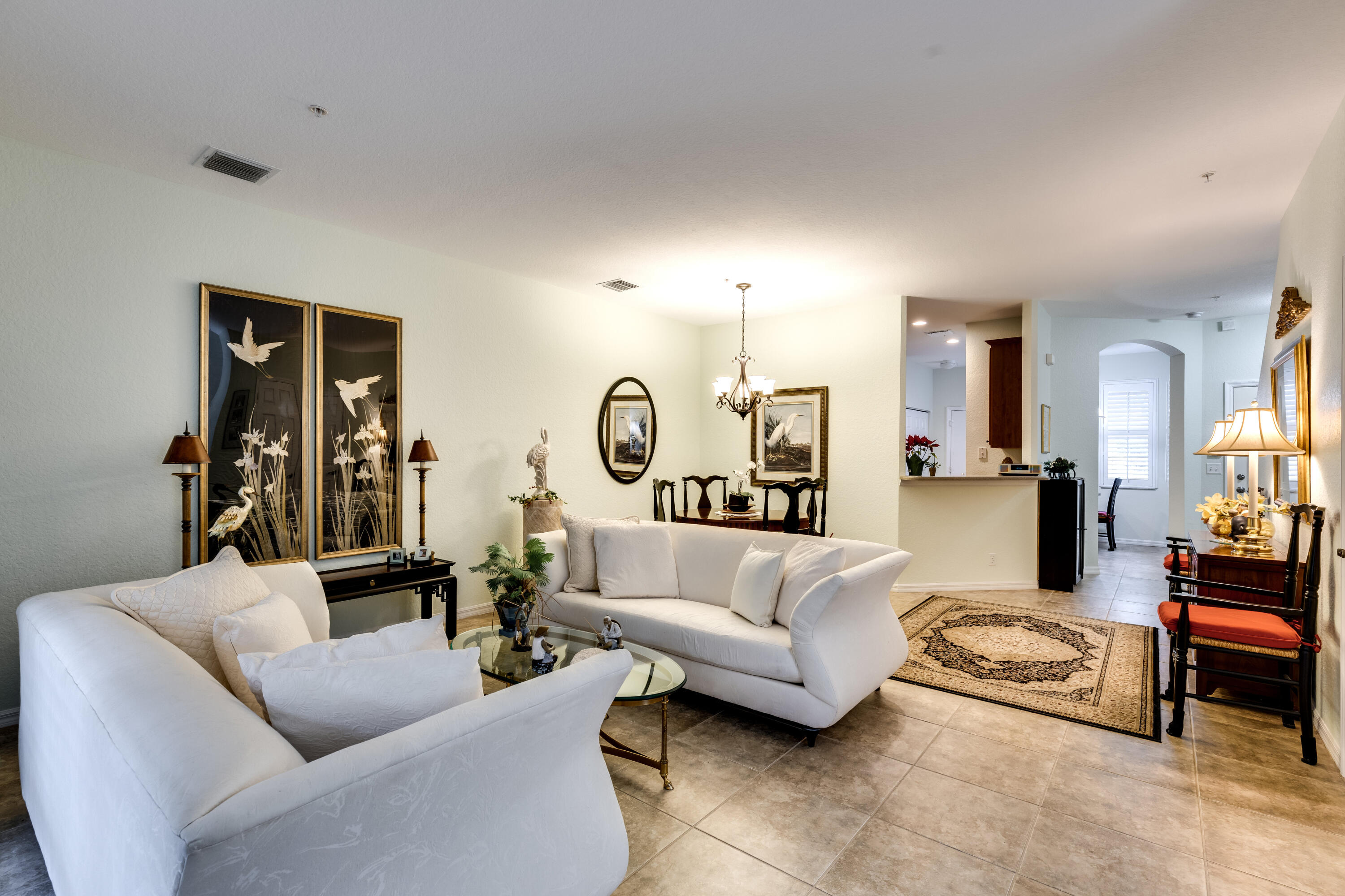 156 Village Boulevard, Unit E Tequesta, FL 33469 - Photo 9 of 36 a living room with furniture and a large window