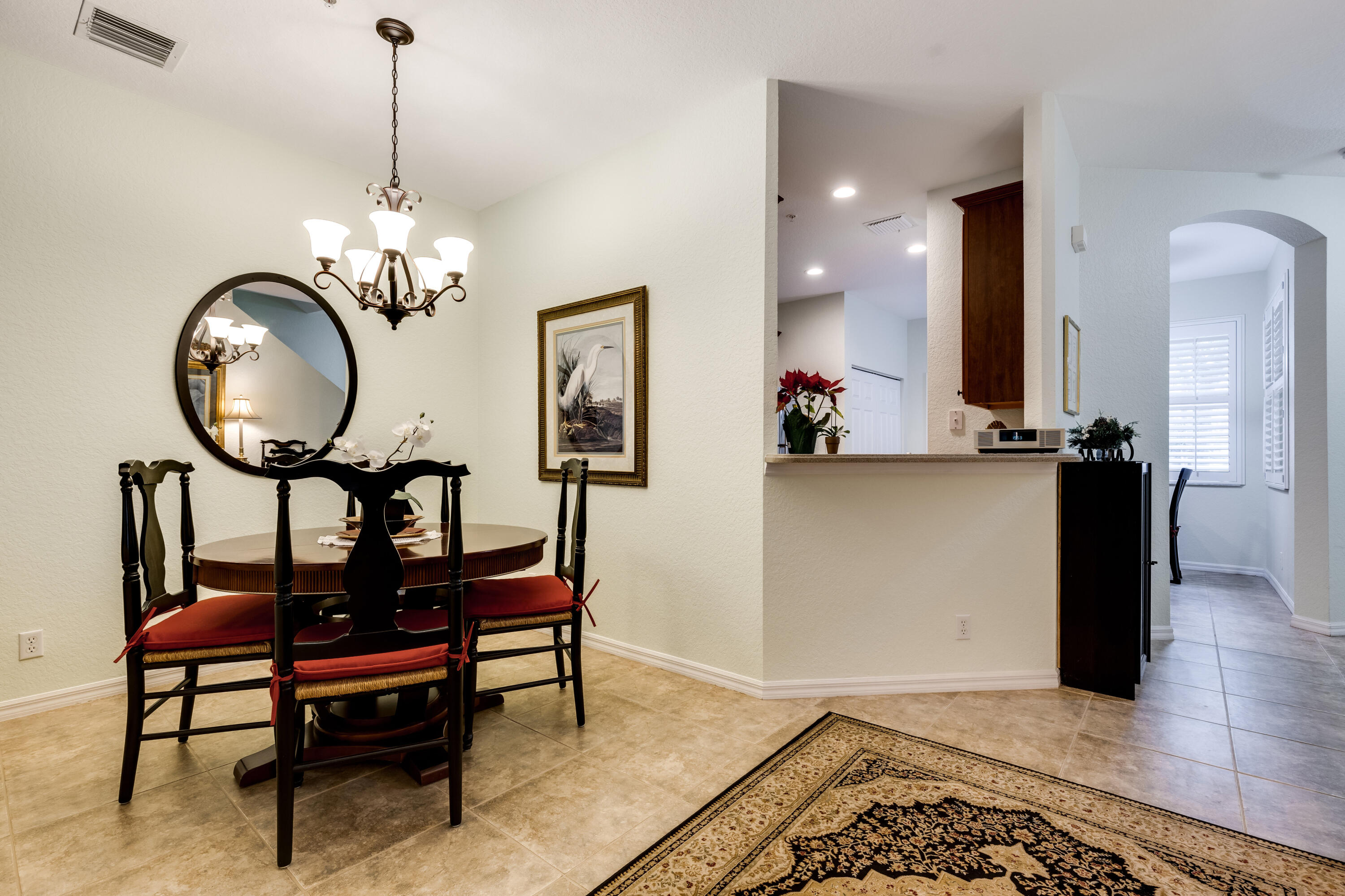 156 Village Boulevard, Unit E Tequesta, FL 33469 - Photo 10 of 36 a view of a livingroom with furniture and a chandelier