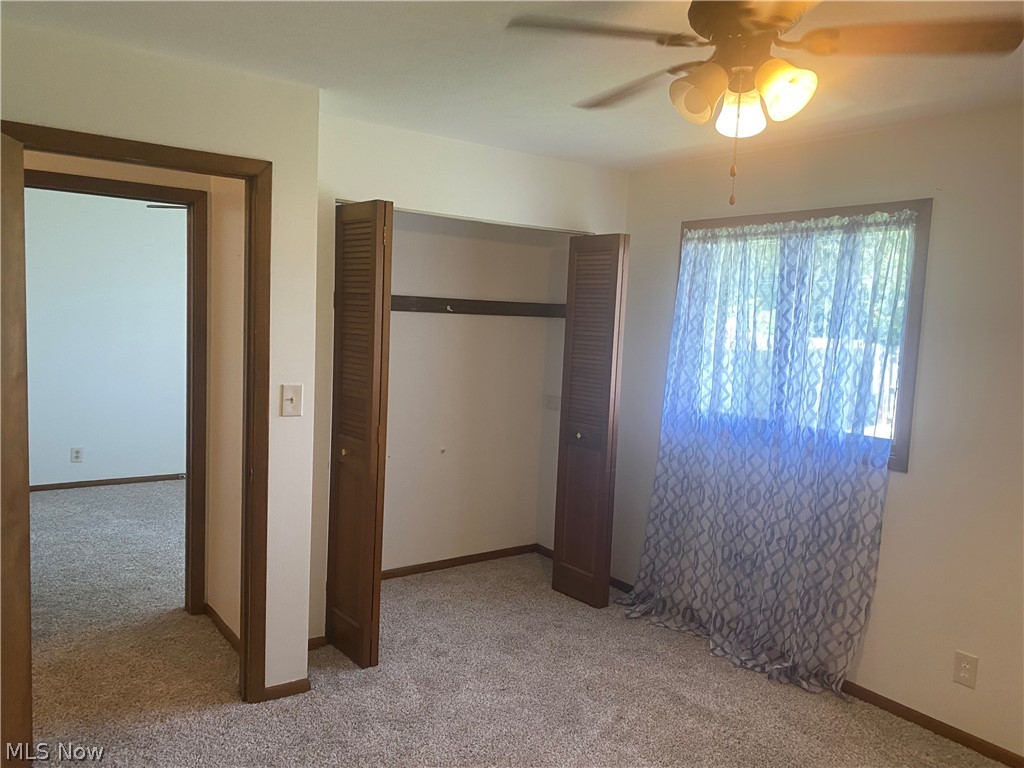 13005 Milo Road Cleveland, OH 44125 - Photo 11 of 33 Unfurnished bedroom with carpet flooring, a closet, and ceiling fan